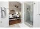 Contemporary bathroom with a glass shower and view into a spacious bedroom with stylish furnishings at 11244 Playa Caribe Ave, Las Vegas, NV 89138