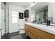 Modern bathroom with double sink vanity, glass-enclosed shower, and contemporary fixtures at 11244 Playa Caribe Ave, Las Vegas, NV 89138