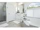 Elegant bathroom featuring a soaking tub, glass-enclosed shower, and stylish white cabinetry at 11244 Playa Caribe Ave, Las Vegas, NV 89138