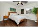 Comfortable bedroom featuring a wooden bed frame, hardwood floors, and contemporary wall art at 11244 Playa Caribe Ave, Las Vegas, NV 89138