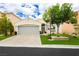 Charming single-story home featuring a manicured front yard, artificial turf, and a two-car garage at 11244 Playa Caribe Ave, Las Vegas, NV 89138