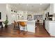 Bright kitchen with white cabinets, stainless steel appliances, an island with seating, and wood-look flooring at 11244 Playa Caribe Ave, Las Vegas, NV 89138