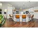 Bright kitchen features white cabinetry, stainless steel appliances and breakfast bar seating at 11244 Playa Caribe Ave, Las Vegas, NV 89138