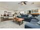 An open concept living room with modern furniture, flowing into a breakfast bar and kitchen at 11244 Playa Caribe Ave, Las Vegas, NV 89138