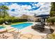 Beautiful backyard with a stunning pool, rock landscaping, and relaxing lounge furniture at 11244 Playa Caribe Ave, Las Vegas, NV 89138