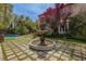 Gorgeous backyard with tiered fountain, lush landscaping, and a sparkling swimming pool at 11814 Canons Brook Dr, Las Vegas, NV 89141