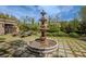 Beautiful backyard featuring a tiered fountain, manicured lawn, and chaise lounges for relaxing at 11814 Canons Brook Dr, Las Vegas, NV 89141