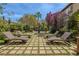 Outdoor space featuring tiered fountain, landscaping, pool, and comfortable lounge chairs at 11814 Canons Brook Dr, Las Vegas, NV 89141