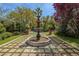 Backyard fountain, lush landscaping, and hardscape create a serene outdoor oasis at 11814 Canons Brook Dr, Las Vegas, NV 89141