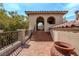 Covered balcony with tiled flooring, wrought iron railing, and tranquil views of the surrounding landscape at 11814 Canons Brook Dr, Las Vegas, NV 89141