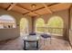 Covered balcony with tiled flooring, comfortable seating, and scenic views, perfect for relaxing outdoors at 11814 Canons Brook Dr, Las Vegas, NV 89141