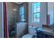 Bathroom featuring a brick-style shower, decorative tile work, and a bright window at 11814 Canons Brook Dr, Las Vegas, NV 89141