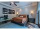 This bedroom includes wood floors, a ceiling fan, backyard access, and a writing desk at 11814 Canons Brook Dr, Las Vegas, NV 89141
