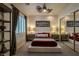 This bedroom features neutral colors, a decorative fan, and an eye-catching piece of artwork above the bed at 11814 Canons Brook Dr, Las Vegas, NV 89141