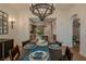 Dining room with seating for six, wood floors, chandelier, and kitchen access at 11814 Canons Brook Dr, Las Vegas, NV 89141