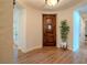 Inviting foyer featuring a wood door, neutral walls, and wood-look floors at 11814 Canons Brook Dr, Las Vegas, NV 89141