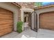 Close up of driveway gate leading to inner court, and two car garage at 11814 Canons Brook Dr, Las Vegas, NV 89141