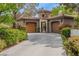 Beautiful home with a stone tower, two-car garages, and lush landscaping at 11814 Canons Brook Dr, Las Vegas, NV 89141