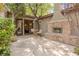 Cozy outdoor patio with a stone fireplace and comfortable seating area at 11814 Canons Brook Dr, Las Vegas, NV 89141