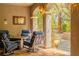 Inviting outdoor patio with comfortable seating, a stone pillar archway, and lush greenery, creating a peaceful retreat at 11814 Canons Brook Dr, Las Vegas, NV 89141