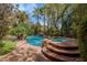 Inviting swimming pool and spa surrounded by lush landscaping and a rock waterfall feature at 11814 Canons Brook Dr, Las Vegas, NV 89141