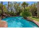 Gorgeous swimming pool with a rock waterfall and lush landscaping at 11814 Canons Brook Dr, Las Vegas, NV 89141