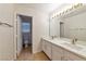 Bathroom featuring double sinks, large mirror, and separate toilet area at 121 Golf Course St, Las Vegas, NV 89145