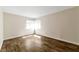 A bedroom with wood flooring and plenty of natural light from two windows at 121 Golf Course St, Las Vegas, NV 89145