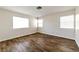Comfortable bedroom featuring wood-like flooring and bright windows for plenty of light at 121 Golf Course St, Las Vegas, NV 89145
