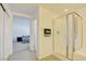 Bright bathroom featuring tiled floors, shower with glass door, and doorway into bedroom at 12391 Pinetina St, Las Vegas, NV 89141