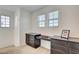 Bedroom area includes built-in desk, dark wood cabinetry, and natural light from three windows at 12391 Pinetina St, Las Vegas, NV 89141