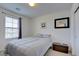 Cozy bedroom with neutral tones, a comfortable bed, and a window with natural light at 12391 Pinetina St, Las Vegas, NV 89141