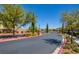 Community entrance featuring manicured landscaping and a decorative stone entrance at 12391 Pinetina St, Las Vegas, NV 89141