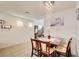 Open dining area with a stylish light fixture and views of the staircase at 12391 Pinetina St, Las Vegas, NV 89141