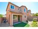 Rear exterior view of a two-story home, showcasing a covered patio and landscaping at 12391 Pinetina St, Las Vegas, NV 89141