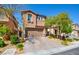 Charming front exterior of a two-story home featuring a brick driveway and desert landscaping at 12391 Pinetina St, Las Vegas, NV 89141