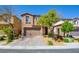 Charming front exterior of a two-story home featuring a brick driveway and desert landscaping at 12391 Pinetina St, Las Vegas, NV 89141