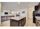 Open kitchen layout with island featuring granite countertops and seamless flow to the living area at 12391 Pinetina St, Las Vegas, NV 89141