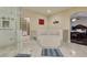 Bright bathroom features a shower, soaking tub on raised platform, and entrance to walk-in closet in view of bedroom at 1341 Marina Del Rey Ct, Las Vegas, NV 89117