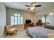 Bright bedroom featuring a ceiling fan, wood floors, a shuttered window, and mirrored closet at 1341 Marina Del Rey Ct, Las Vegas, NV 89117