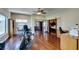Bright exercise room with hardwood floors features an exercise bike and a desk with chair in view of a bedroom at 1341 Marina Del Rey Ct, Las Vegas, NV 89117
