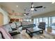 Open-concept living room features a large sectional sofa, ceiling fans, and sliding doors to outdoor patio area at 1341 Marina Del Rey Ct, Las Vegas, NV 89117
