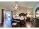 Comfortable bedroom featuring hardwood floors, a ceiling fan, and access to an adjacent room or patio at 1341 Marina Del Rey Ct, Las Vegas, NV 89117