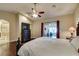 Inviting main bedroom with hardwood floors, ceiling fan, and access to a sitting room and ensuite bathroom at 1341 Marina Del Rey Ct, Las Vegas, NV 89117