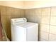 Laundry room features a white dryer and beige tile flooring at 1520 Henry Dr, Las Vegas, NV 89110