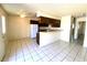 Bright kitchen features a white refrigerator, wood cabinets, and a tiled floor at 1524 Henry Dr, Las Vegas, NV 89110