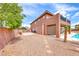 Backyard view of two-story house featuring desert landscaping at 193 Glenbrook Estates Dr, Las Vegas, NV 89183
