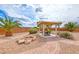 Landscaped backyard with pergola, outdoor seating, and fire pit area at 193 Glenbrook Estates Dr, Las Vegas, NV 89183