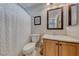 Bathroom featuring toilet, sink, vanity, framed art, large mirror, shower with curtain and neutral walls at 193 Glenbrook Estates Dr, Las Vegas, NV 89183