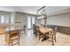 Bright dining room featuring a modern light fixture, breakfast bar, tiled floors, and French doors to the patio at 193 Glenbrook Estates Dr, Las Vegas, NV 89183
